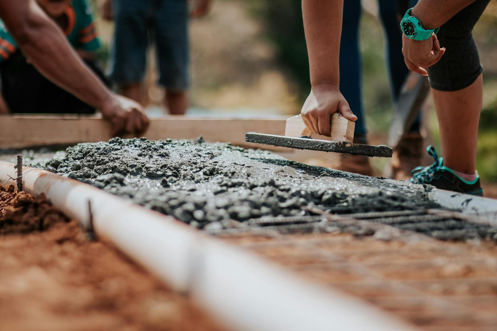 Finishing a concrete pour with a hand float for flatwork and slab edges